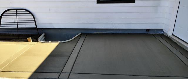 Slab along the house with a window well